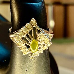 Oval Cut Jade Surrounded By Cubic Zirconia In A Silver Plated Prong Setting